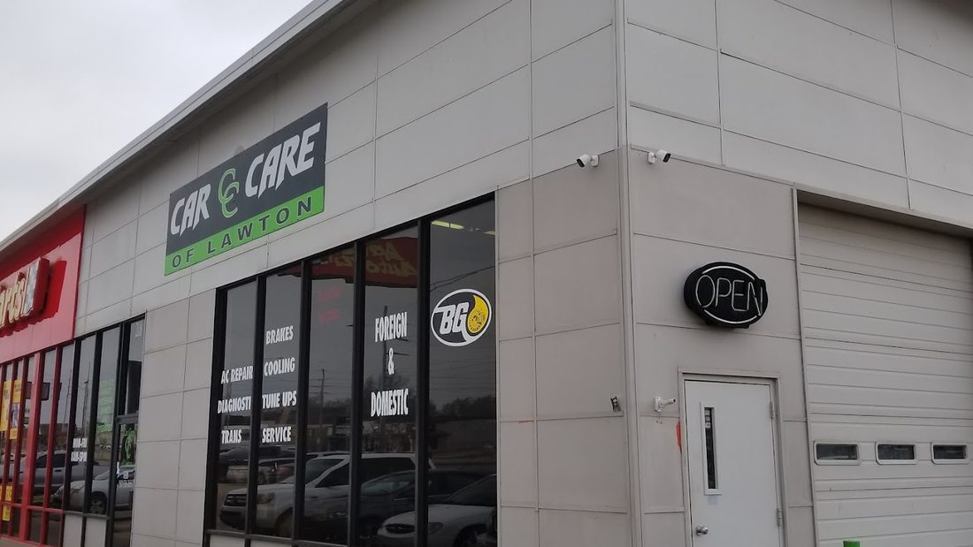 The Car Care of Lawton storefront on NW Cache Road, sign reading Foreign & Domestic with the Open light on.