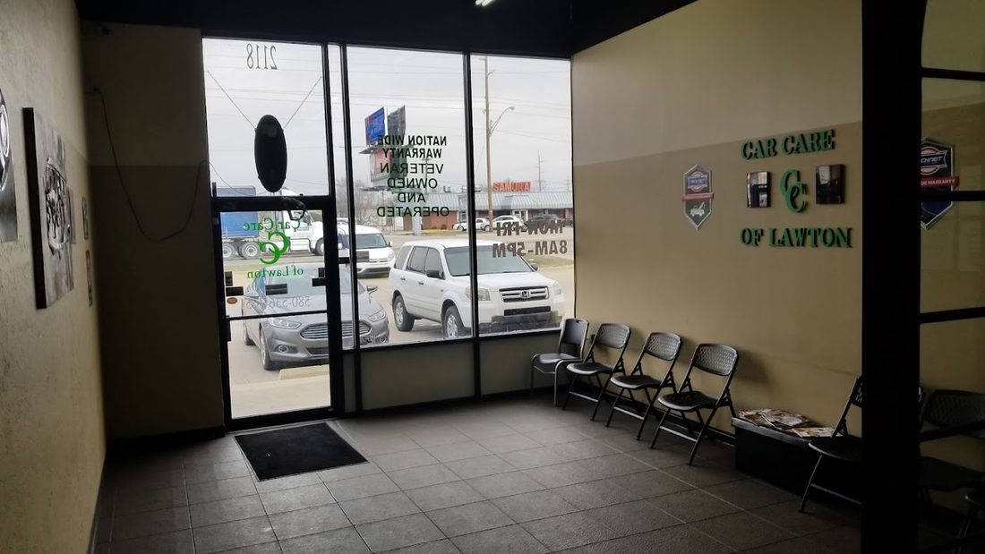 Inside the Car Care of Lawton waiting area, with the wall sign reading Nationwide Warranty, Veteran Owned and Operated.